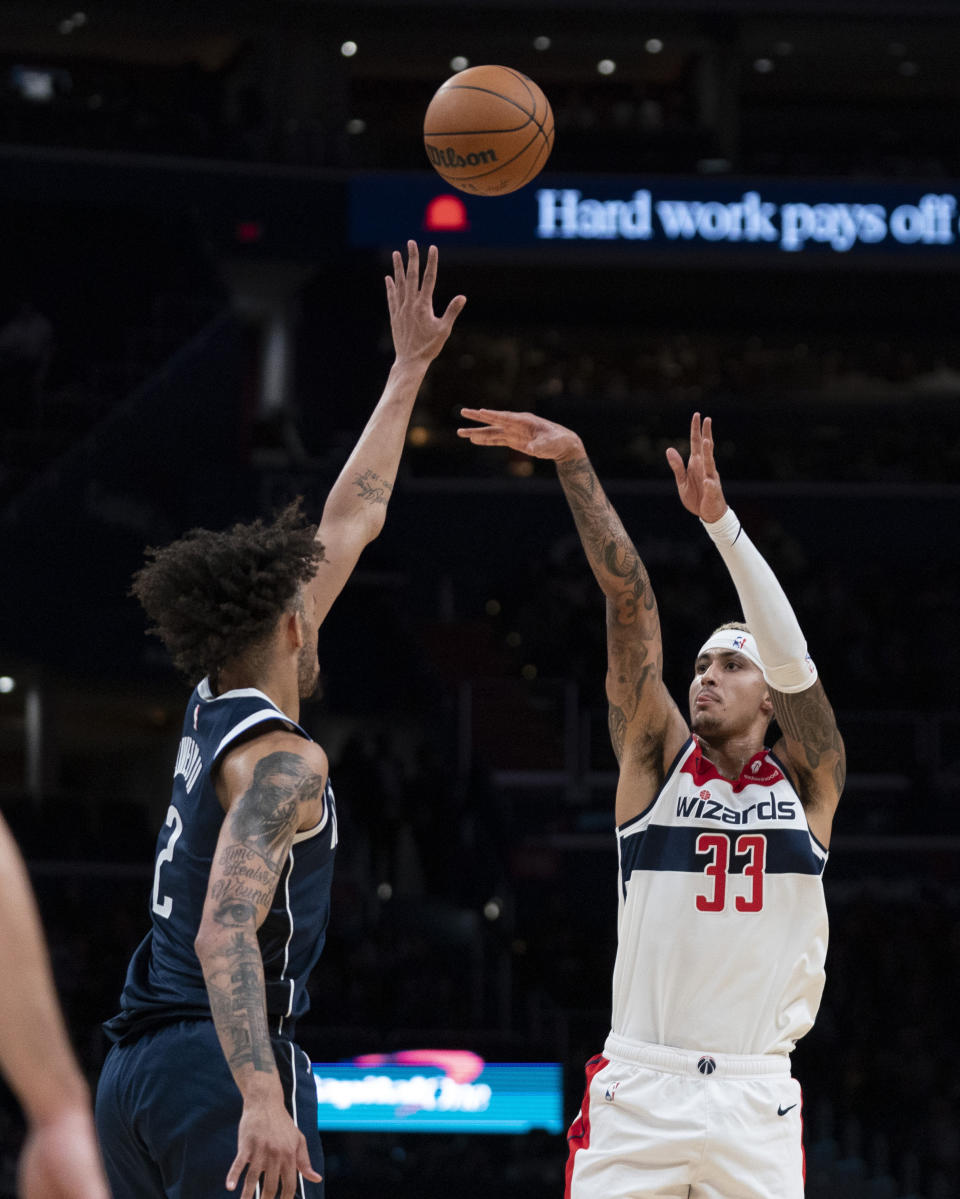 Washington Wizards forward Kyle Kuzma (33) shoots against Dallas Mavericks center Dereck Lively II (2) during the first half of an NBA basketball game Wednesday, Nov. 15, 2023, in Washington. (AP Photo/Stephanie Scarbrough)