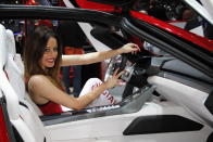 A model poses behind the wheel of the Italdesign Giugiaro Parcour at the 2013 Geneva Motor Show.