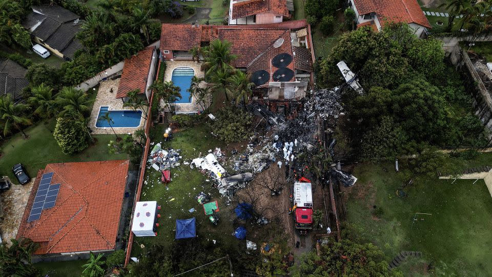 An aerial view of the wreckage of the Voepass flight traveling from Cascavel to Guarulhos that crashed killing all on board. - Nelson Almeida/AFP/Getty Images