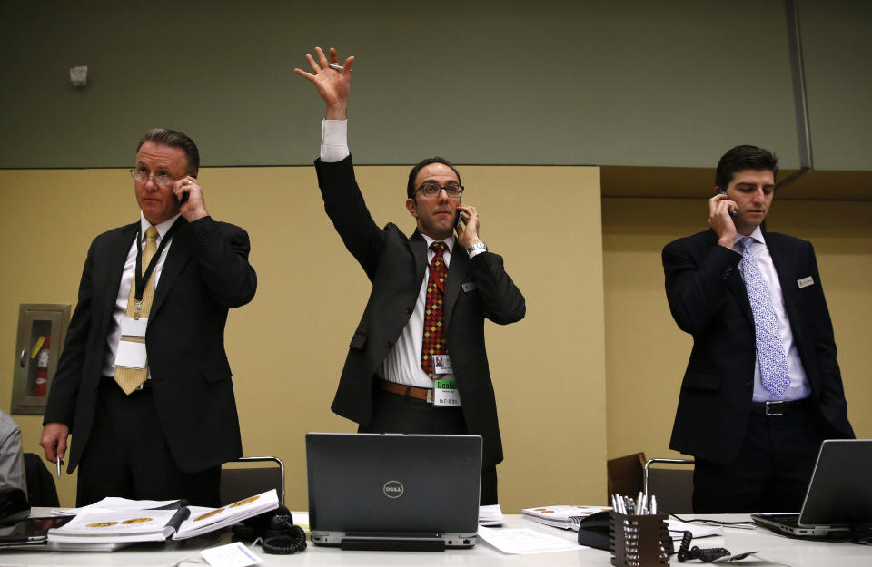 Vicken Yegparian, center, of Stack's and Bowers Galleries, signals a bid from a telephone bidder for the 1936 Nobel Peace Prize medal in Baltimore, Thursday, March 27, 2014. Pictured alongside Yegparian are John Konop, left, and Brian Kendrella, both of Stack's and Bowers. Only the second Nobel Peace Prize to come to auction, it was won by an anonymous telephone bidder for $950,000. The prize sold for a winning bid of $950,000 at auction, and an additional buyer’s commission brought the final sale price to $1.16 million. The prize recipient was Argentina's foreign minister, Carlos Saavedra Lamas, who was honored for his role in negotiating the end of the Chaco War between Paraguay and Bolivia. (AP Photo/Patrick Semansky)