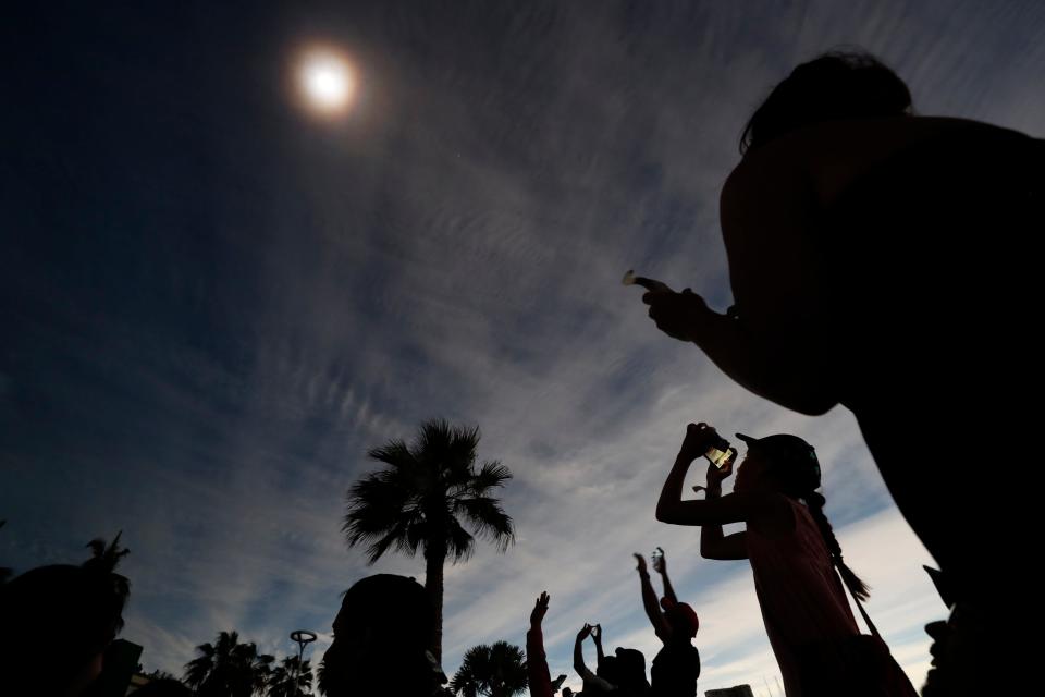 Spectators watch a total solar eclipse in Mazatlan, Mexico on Monday, April 8, 2024.