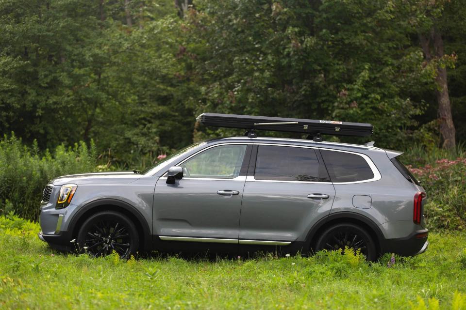 A side view of a gray 2020 Kia Telluride in a field.