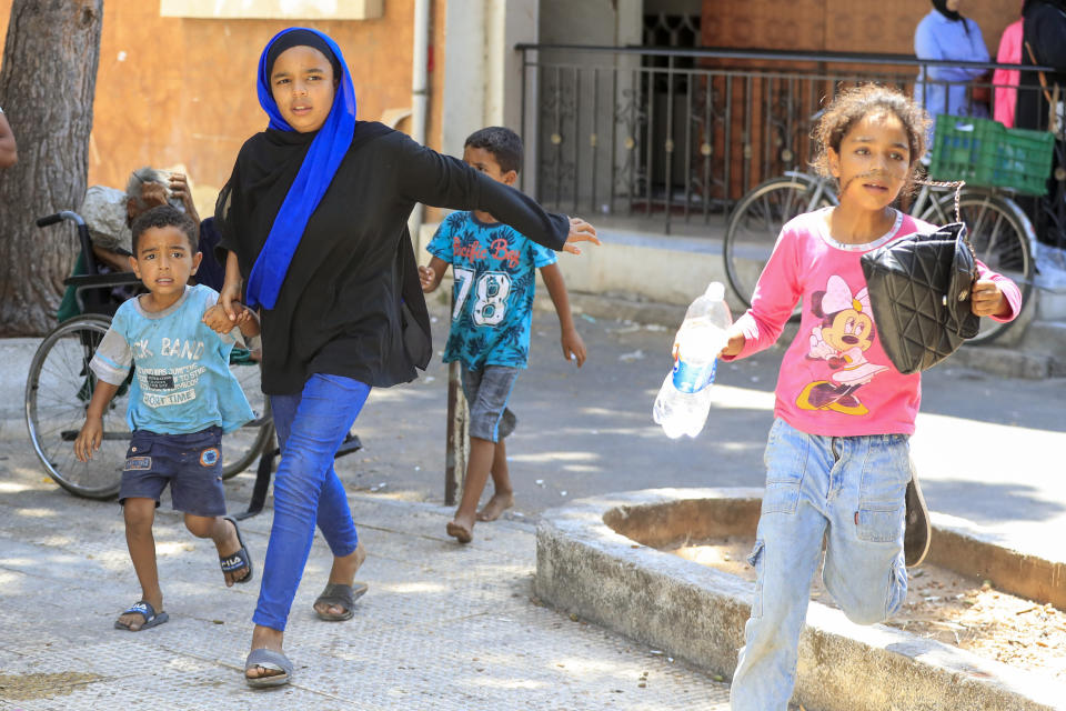 Palestinian residents flee their home after clashes that erupted between members of the Palestinian Fateh group and Islamist militants in the Palestinian refugee camp of Ein el-Hilweh near the southern port city of Sidon, Lebanon, Sunday, July 30, 2023. Palestinian officials say at least five people have been killed and several others wounded during clashes in Lebanon’s largest Palestinian refugee camp. (AP Photo/Mohammad Zaatari)