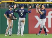 Sep 18, 2017; Pittsburgh, PA, USA; Milwaukee Brewers center fielder Brett Phillips (left) and left fielder Ryan Braun (8) and right fielder Hernan Perez (right) celebrate in the outfield after defeating the Pittsburgh Pirates at PNC Park. Mandatory Credit: Charles LeClaire-USA TODAY Sports