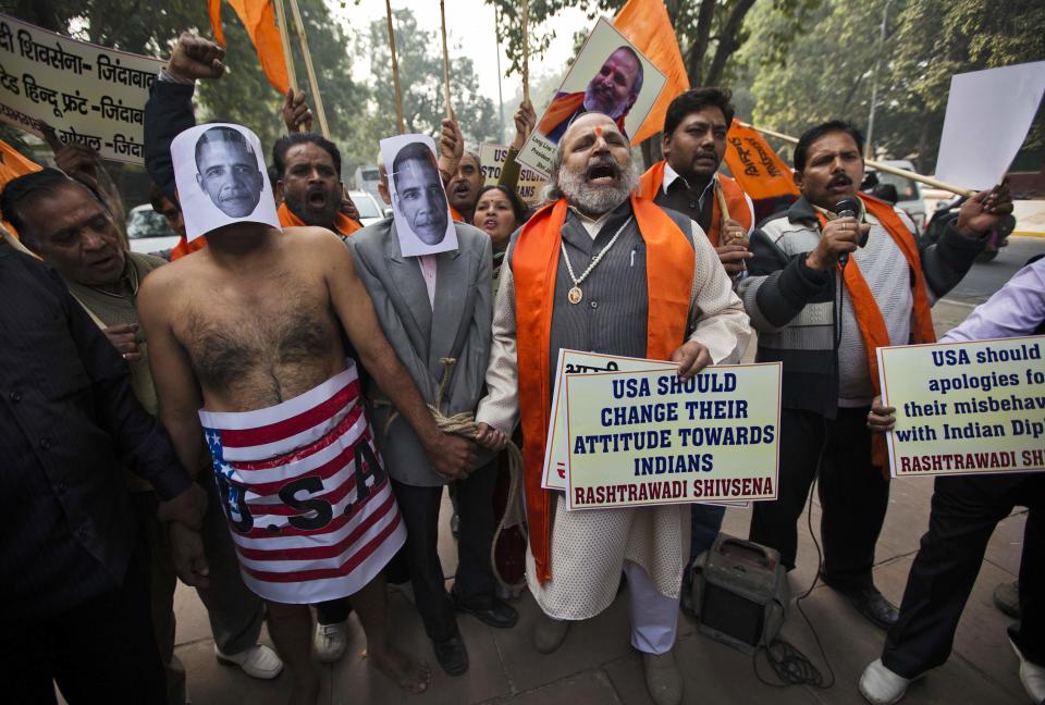 Supporters of Rashtrawadi Shiv Sena, a Hindu hardline group, shout anti-U.S. slogans during a protest near the U.S. embassy in New Delhi December 18, 2013. Indian police removed concrete security barriers outside the U.S. Embassy in New Delhi on Tuesday in apparent retaliation for the treatment of an Indian diplomat who was strip-searched after her arrest in New York last week. The diplomatic spat was triggered by the December 12 arrest of Devyani Khobragade, a deputy consul general at the Indian Consulate in New York, on charges of visa fraud and making false statements for allegedly lying about how much she paid her housekeeper, an Indian national. (REUTERS/Ahmad Masood)