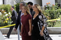 FILE - Carli Skaggs, front left, walks into St. Monica Catholic Church for a memorial for her husband, Los Angeles Angels pitcher Tyler Skaggs, in Los Angeles, Monday, July 22, 2019. A former Angels employee was convicted Thursday, Feb. 17, 2022, of providing Angels pitcher Skaggs the drugs that led to his overdose death in Texas. (AP Photo/Marcio Jose Sanchez, File)