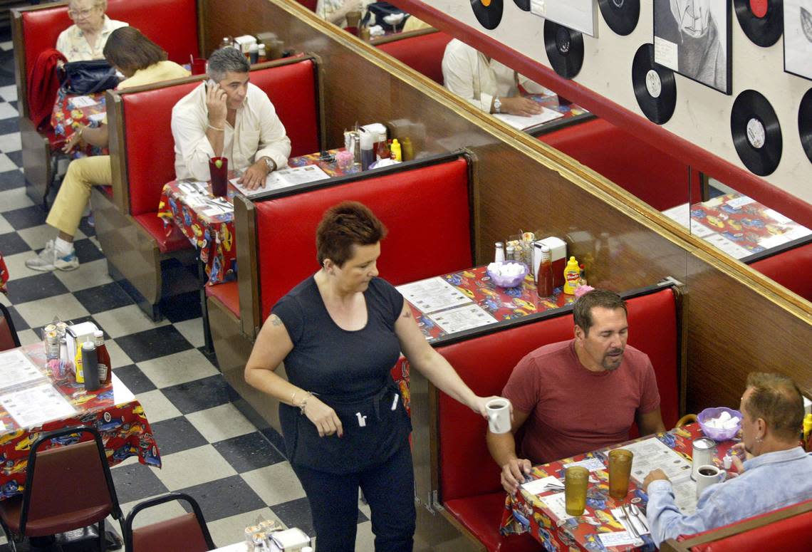 Anna Moussa serves coffee to patrons in 2004 at the diner inside Allen’s Drug Store, at Red and Bird roads in South Miami.