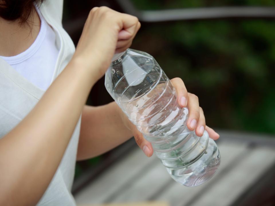 A woman holding a water bottle.