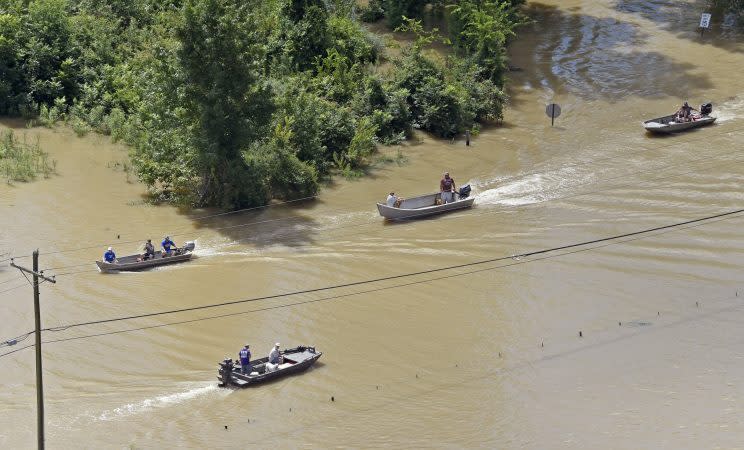 Boats sail on Highway 431, flooded after heavy rains in the Ascension Parish area, south of Baton Rouge earlier this month. (The Advocate via AP)