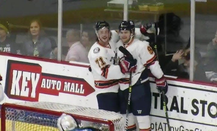 Peoria Rivermen veteran center Alec Baer (right) celebrates his go-ahead goal and second goal of the game with Cayden Cahill late in the second period during the Rivermen regular-season SPHL opener at Quad City on Saturday, Oct. 21, 2023.