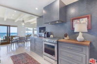 <p>The open-concept kitchen has modern appliances and plenty of colour. (Trulia.com) </p>