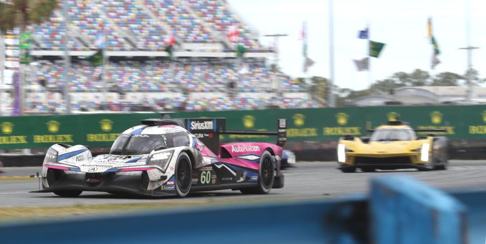 The no. 60- Acura ARX-06 is chased by the no. 01 Cadillac LMDh in the east horseshoe, Sunday January 29, 2023 during the Rolex 24 at Daytona International Speedway