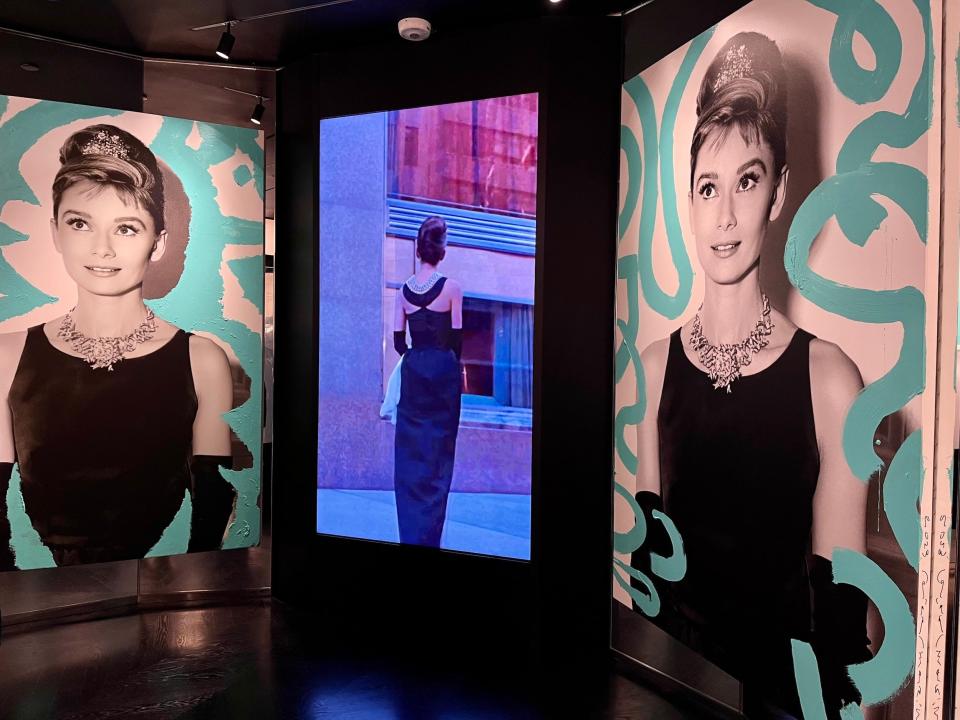 Audrey Hepburn photos displayed next to screen playing "Breakfast at Tiffany's"