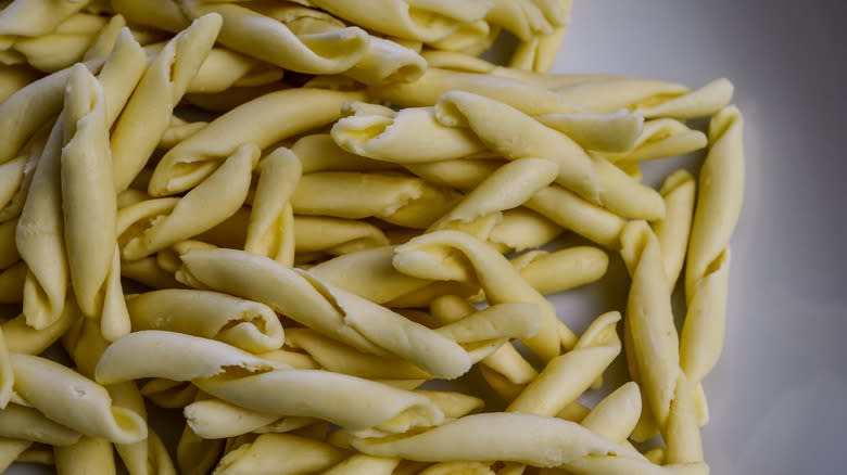 Dried strozzapreti pasta on table