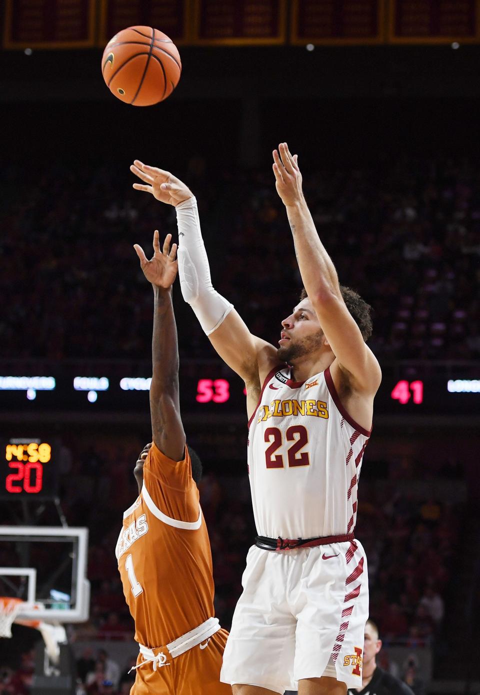 Iowa State's Gabe Kalscheur (22) attempts a 3-point shot around Texas' Andrew Jones (1) during the second half of Saturday's game at Hilton Coliseum in Ames.