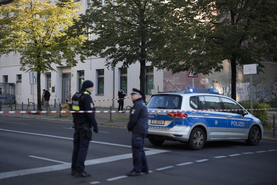 German police officers stand guard in front of the building complex of the Kahal Adass Jisroel community, which houses a synagogue, a kindergarten and a community center, in the center of Berlin, Germany, Wednesday, Oct. 18, 2023. The Kahal Adass Jisroel community said its synagogue in the city's Mitte neighborhood was attacked with two incendiary devices. Police confirmed the incident. (AP Photo/Markus Schreiber)