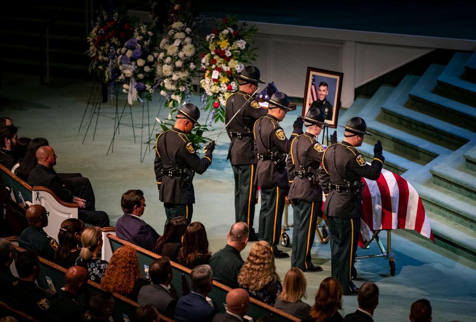 A Polk County sheriff's honor guard stands at attention at Deputy Blane Lane's casket on Tuesday.