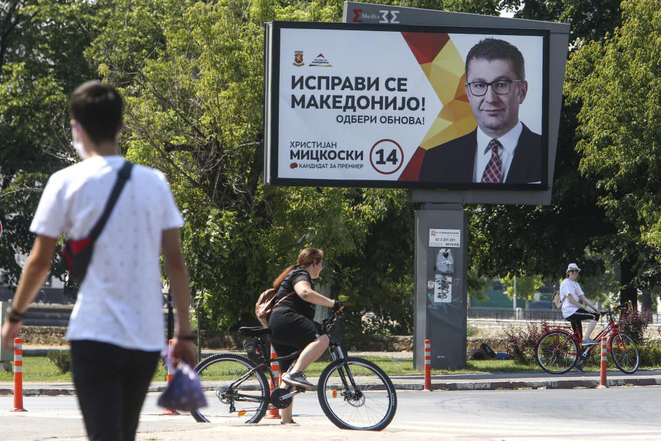 An election campaign poster of the leader of the largest opposition party VMRO-DPMNE Hristijan Mickoski, is displayed in a street in Skopje, North Macedonia on Saturday, July 11, 2020. North Macedonia holds its first parliamentary election under its new country name this week, with voters heading to the polls during an alarming spike of coronavirus cases in the small Balkan nation. (AP Photo/Boris Grdanoski)