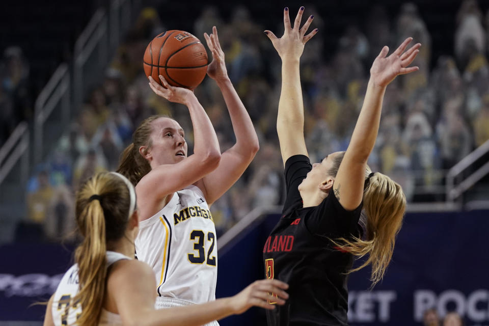 Michigan guard Leigha Brown (32) shoots over the defense of Maryland guard Faith Masonius during the first half of an NCAA college basketball game, Thursday, March 4, 2021, in Ann Arbor, Mich. (AP Photo/Carlos Osorio)