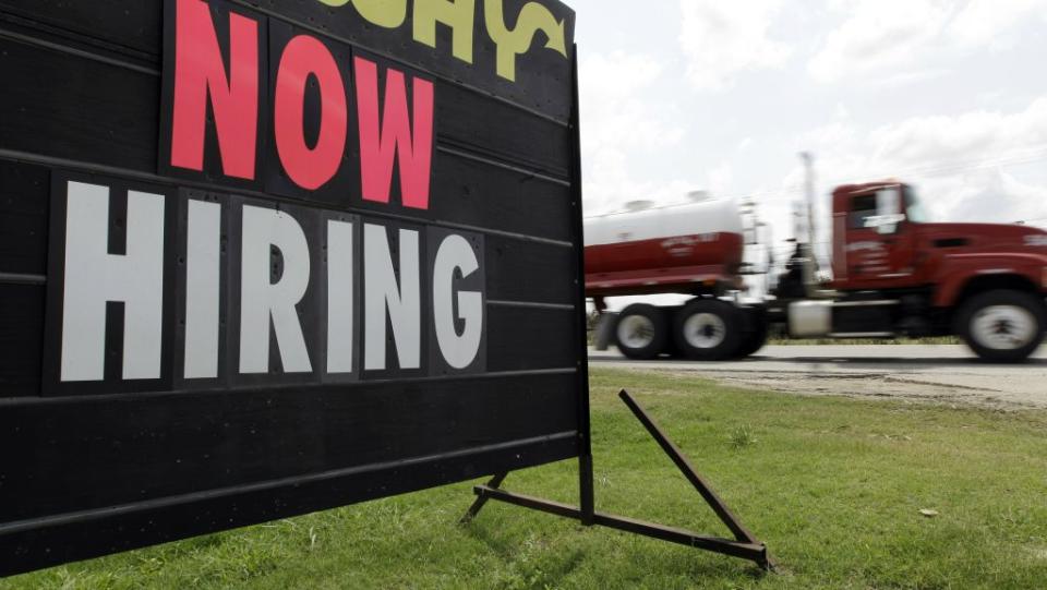 A "Now Hiring" sign