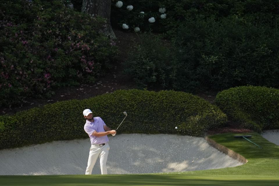 Scottie Scheffler hits from the bunker on the 12th hole during a practice round in preparation for the Masters golf tournament at Augusta National Golf Club Wednesday, April 10, 2024, in Augusta, GA. (AP Photo/Ashley Landis)