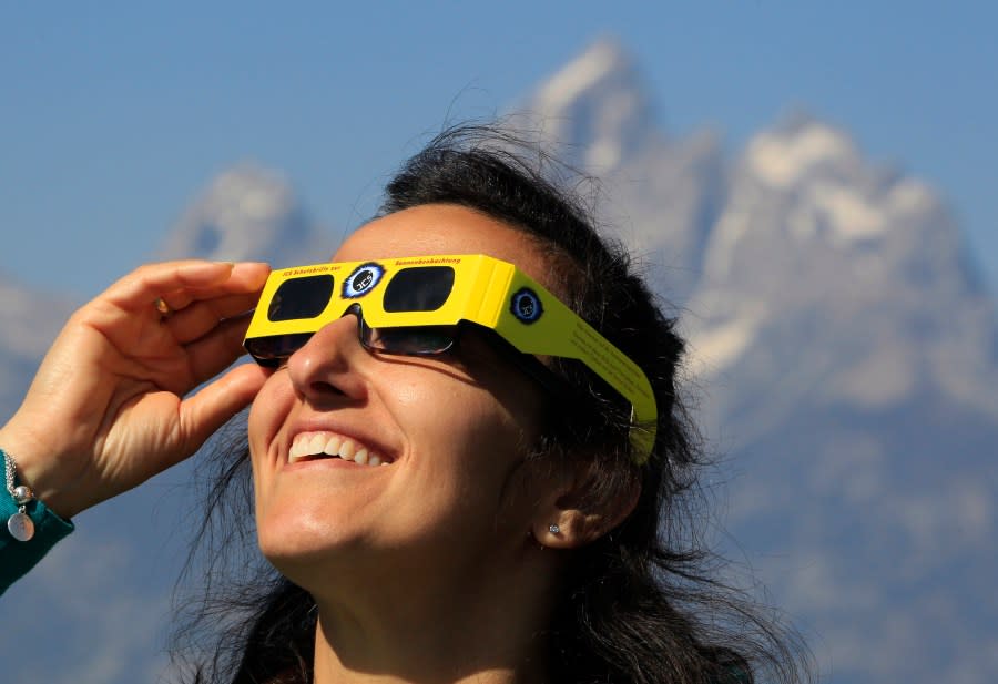 <em>JACKSON, WY – AUGUST 21: A woman views the solar eclipse in the first phase of a total eclipse in Grand Teton National Park on August 21, 2017 outside Jackson, Wyoming. (Photo by George Frey/Getty Images)</em>