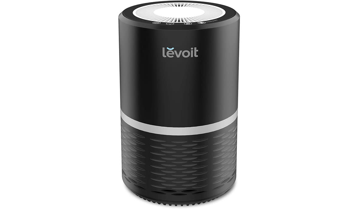 Black cylindrical air purifier with Levoit logo on the front. 