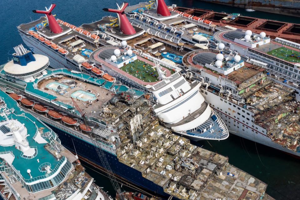 Aerial view from a drone, five luxury cruise ships are seen being broken down for scrap.