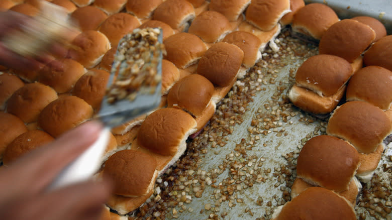 white castle sliders being prepared on a professional grill