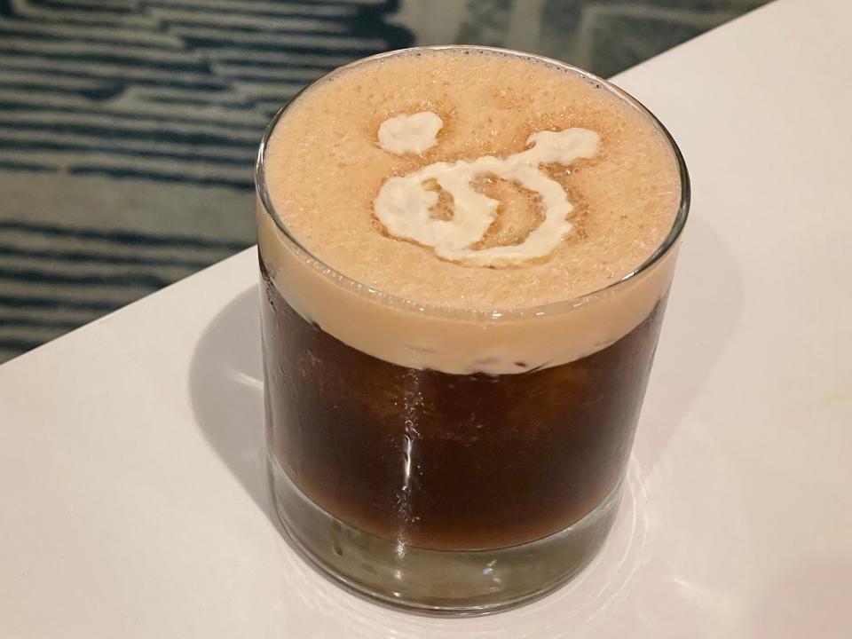 curious cold brew cockatil with mickey mouse foam from steakhouse 71 in disney world