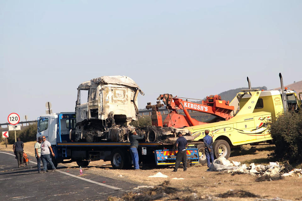 A section of a main freeway, at the Mooi River Plaza in the KwaZulu-Natal Province, South Africa, is blocked off, Saturday, July 10, 2021 after trucks were set alight in overnight protests by supporters of former South African president Jacob Zuma who was imprisoned this week for contempt of court. The protesters are demanding that Zuma be released from prison immediately. (AP Photo)