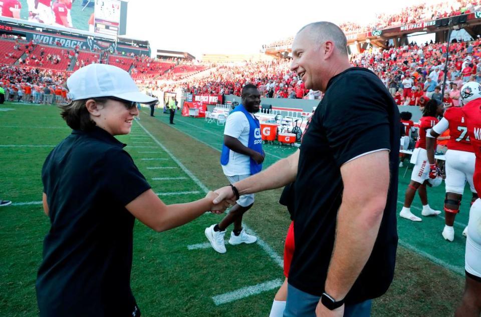 N.C. State head coach Dave Doeren congratulates Payton Gibbs after the Wolfpack’s 24-17 victory over Clemson at Carter-Finley Stadium in Raleigh, N.C., Saturday, Oct. 28, 2023.