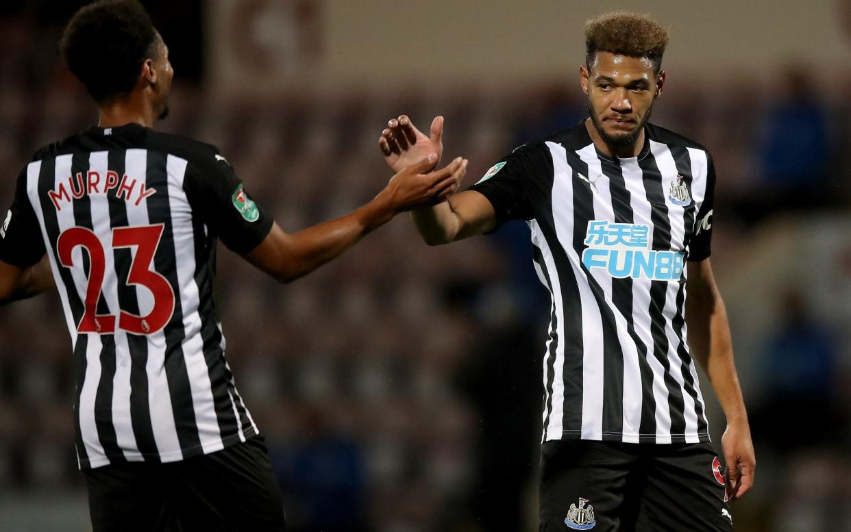 Joelinton celebrates after scoring his sides fourth goal with Newcastle teammate Jacob Murphy - GETTY IMAGES