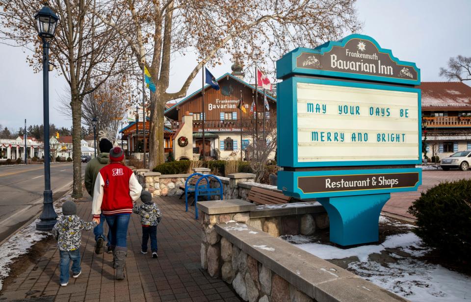 A family walks outside the Bavarian Inn in Frankenmuth on Tuesday, Dec. 20, 2022. 