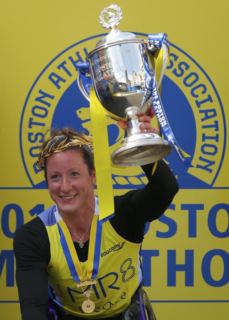 Tatyana McFadden, of the U.S. holds the trophy after winning the women's wheelchair division at the 118th running of the Boston Marathon in Boston, Massachusetts April 21, 2014. (REUTERS/Brian Snyder)