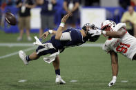 West quarterback Mason Fine, of North Texas, (6) loses the football after getting hit by East defensive end James Smith-Williams, of North Carolina State, (91) during the second half of the East West Shrine football game Saturday, Jan. 18, 2020, in St. Petersburg, Fla. Smith-Williams was called for a facemask penalty. (AP Photo/Chris O'Meara)