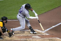 Colorado Rockies' Elehuris Montero, right, doubles off Pittsburgh Pirates starting pitcher Martín Pérez, driving in a run, during the sixth inning of a baseball game in Pittsburgh, Friday, May 3, 2024. (AP Photo/Gene J. Puskar)