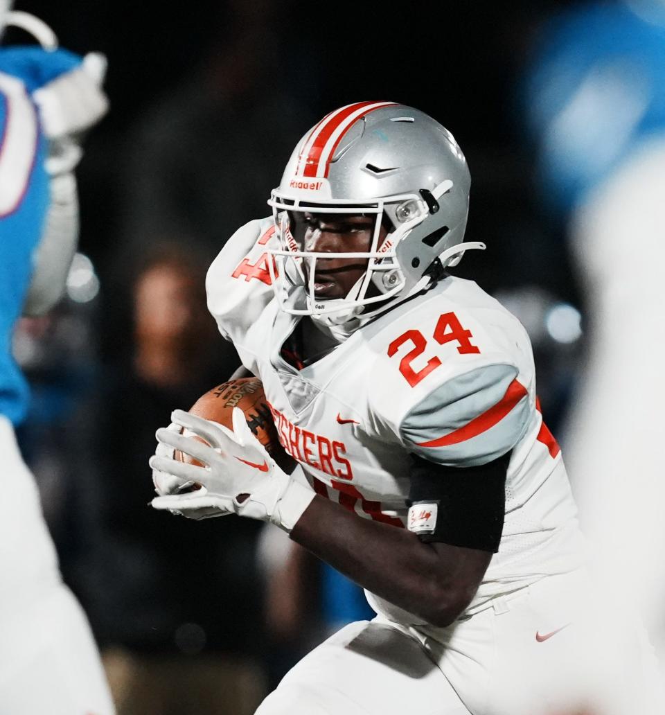 Fishers Tigers running back Khobie Martin (24) runs the ball during the final game of class 6A sectionals between Fishers Tigers and Hamilton Southeastern Royals on Friday, Nov. 3, 2023, at Hamilton Southeastern High School in Fishers. Hamilton Southeastern Royals will move on to regionals after beating Fishers Tigers 38-21.