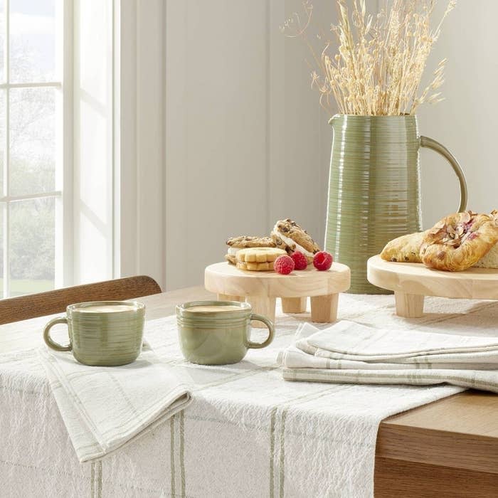 The trays on a table with other decor and dinnerware