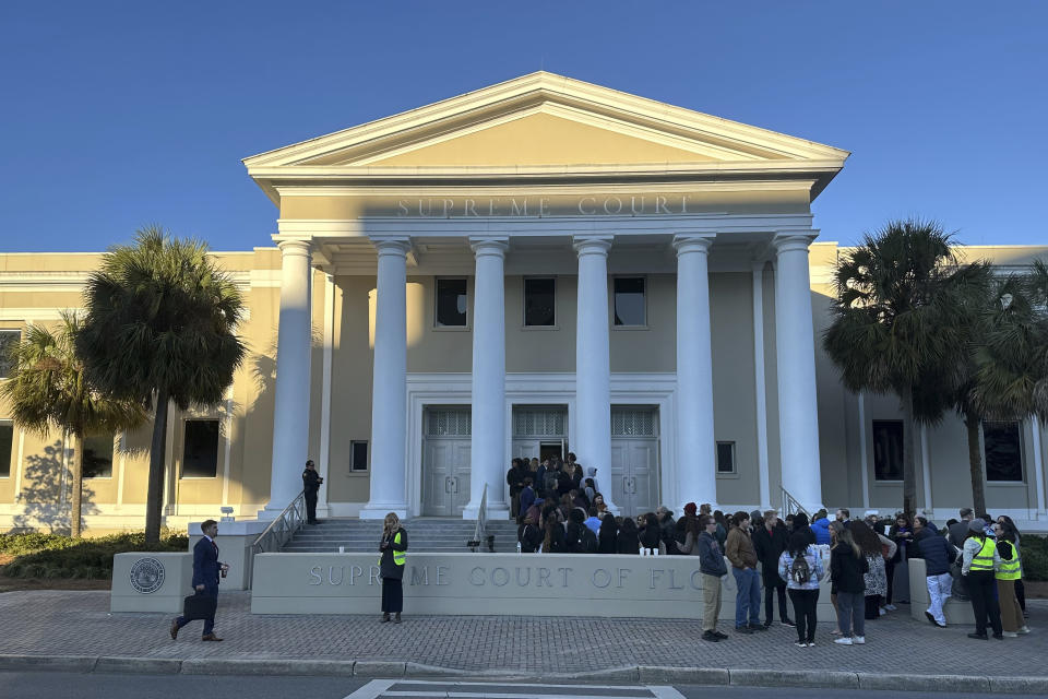 People gather outside the Florida Supreme Court, where justices will hear arguments on a proposed ballot issue regarding abortion on Wednesday, Feb. 7, 2024 in Tallahassee, Fla. Florida's attorney general is expected to ask the state Supreme Court to keep an abortion-rights measure off November's ballot on Wednesday, saying it misleads voters and could be used to expand abortion rights in the future. (AP Photo/Brendan Farrington)