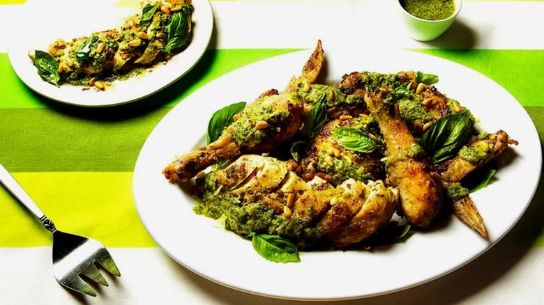 Roasted chicken Genovese on plates with pesto 
