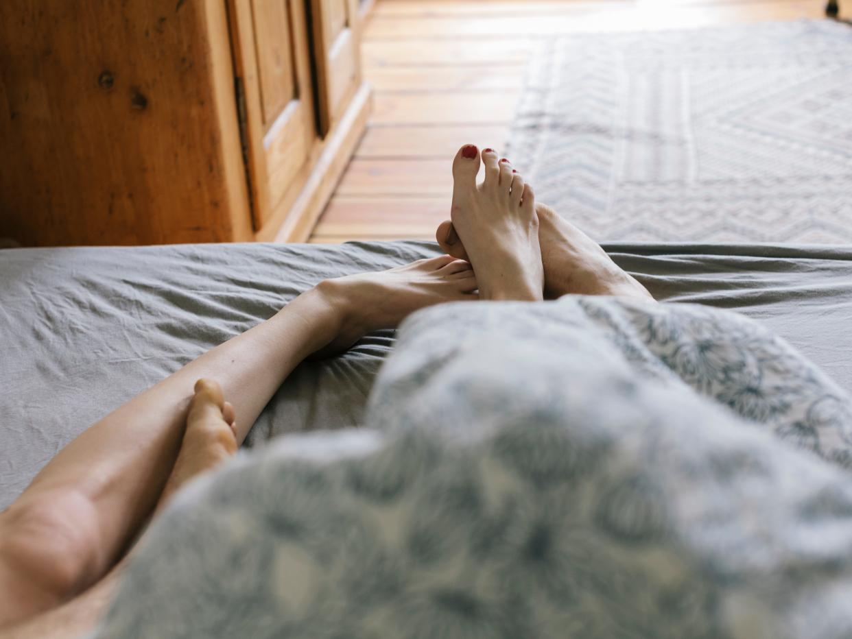 Couple's feet in bed