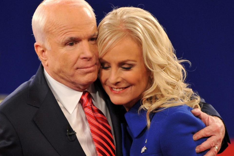 Republican John McCain embraces his wife Cindy following his second presidential debate with Democrat Barack Obama in 2008 (AFP/Getty Images)