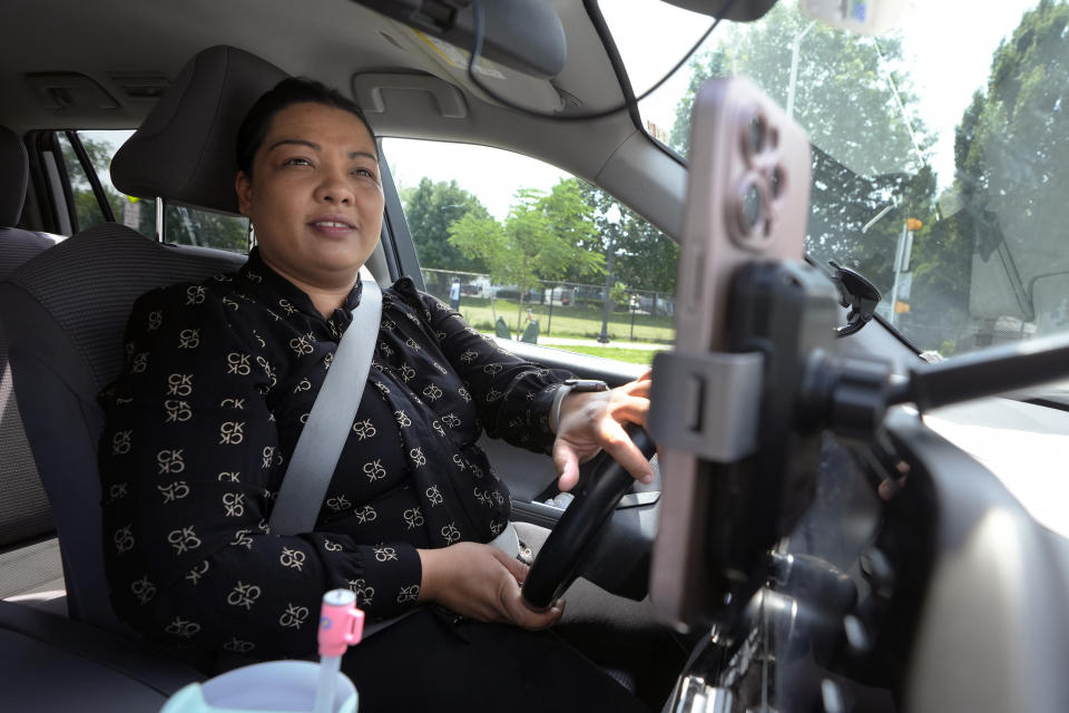 Yolanda Rodriguez, 33, of Malden, Mass., drives her vehicle, in Malden, before going to work for a ride-hailing company, Tuesday, July 9, 2024. Rodriguez, who has driven for Lyft for about six years, says she's convinced that having union rights would benefit her and other drivers. (AP Photo/Steven Senne)