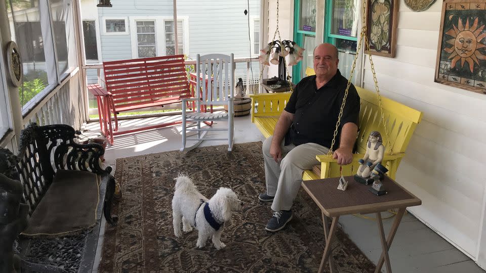 Richard Russell, a certified camp medium and healer, relaxes with his dog, Harley, at home in Cassadaga. - Terry Ward