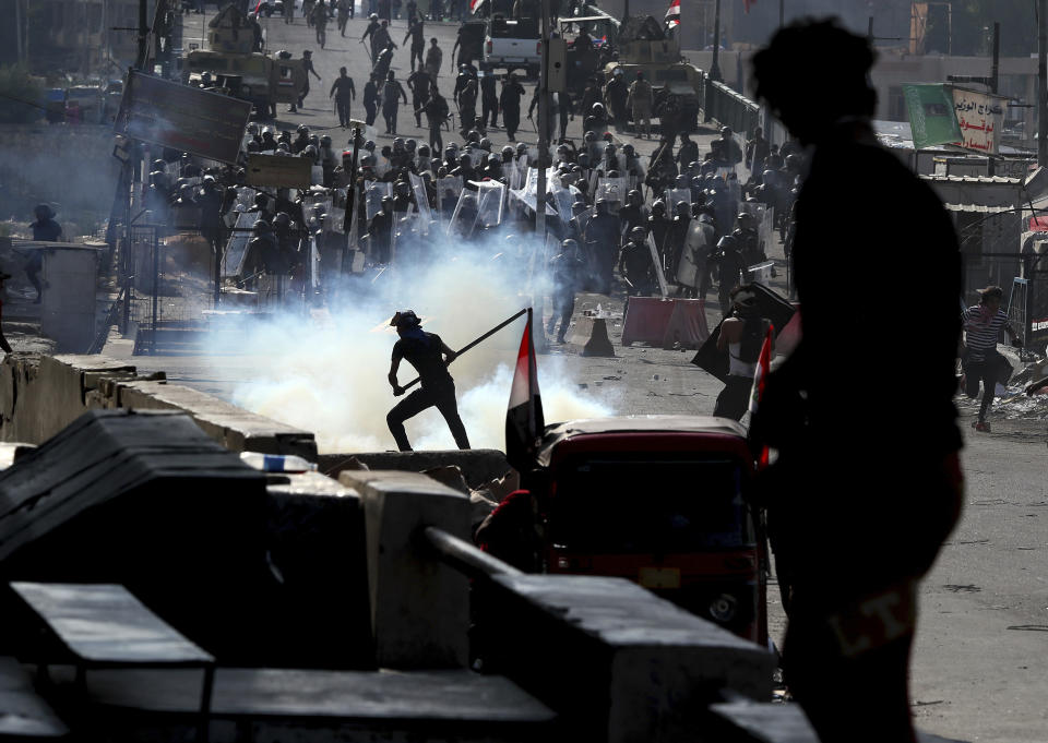 Iraqi riot police fire tear gas to disperse anti-government protesters gathering on the al- Shuhada (Martyrs) bridge in central Baghdad, Iraq, Thursday, Nov. 7, 2019. Tens of thousands of people have taken to the streets in recent weeks in Iraq to protest widespread corruption, a lack of job opportunities and poor basic services, despite Iraq’s vast oil reserves. (AP Photo/Hadi Mizban)