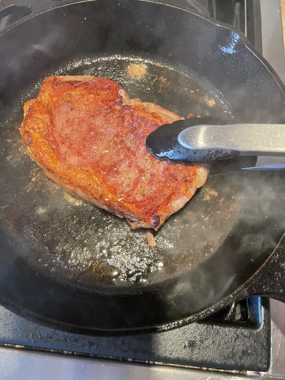 The steak should easily release from the pan when flipping. If the steak resists, allow to cook another minute or two before flipping. (Katie Stilo)