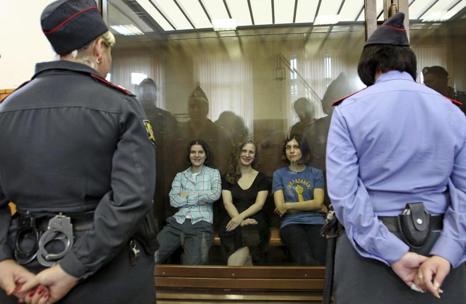 <span class="caption">Members of the feminist punk group Pussy Riot sit in a glass cage at a courtroom in Moscow in 2012. The women were charged with hooliganism connected to religious hatred.</span> <span class="attribution"><a class="link " href="https://newsroom.ap.org/detail/RussiaUnderPutin/605274096ba046d1bf817af231b98a25/photo?Query=pussy%20riot&mediaType=photo&sortBy=arrivaldatetime:desc&dateRange=Anytime&totalCount=1156&currentItemNo=177" rel="nofollow noopener" target="_blank" data-ylk="slk:AP Photo/Mikhail Metzel;elm:context_link;itc:0;sec:content-canvas">AP Photo/Mikhail Metzel</a></span>