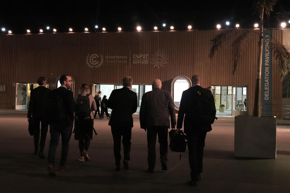 Frans Timmermans, executive vice president of the European Commission, second from right, walks through the COP27 U.N. Climate Summit on his way out on Friday, Nov. 18, 2022, in Sharm el-Sheikh, Egypt. (AP Photo/Nariman El-Mofty)