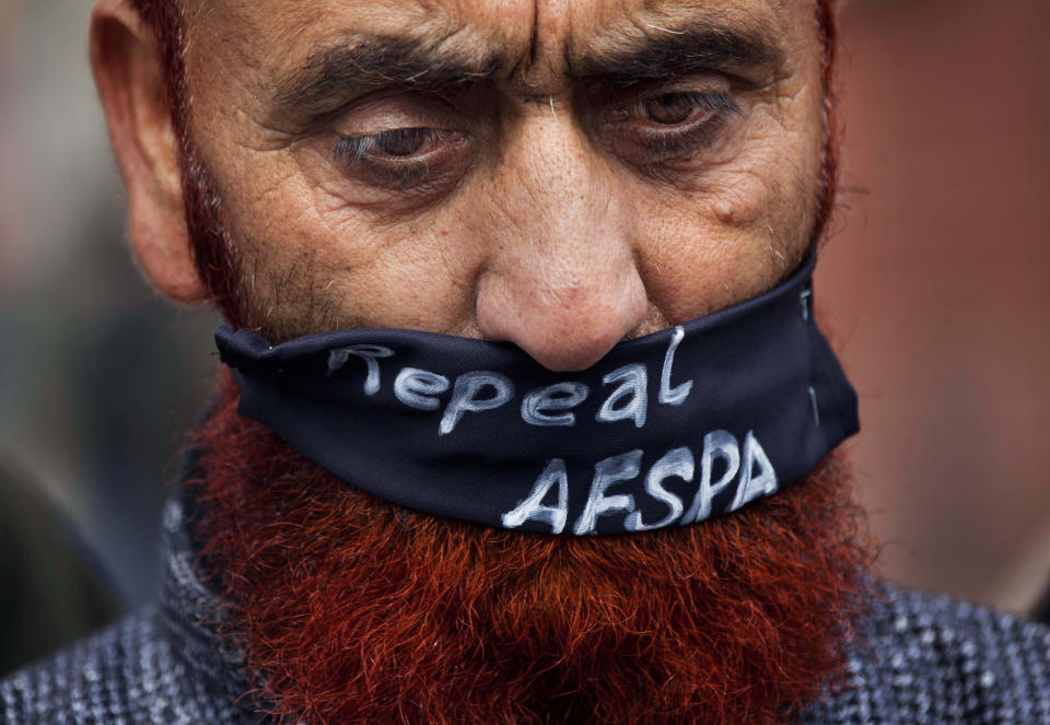 FILE - In this Saturday, Feb. 15, 2014, file photo, a relative of a missing Kashmiri wears a scarf asking for the Armed Forces Special Powers Act (AFSPA) to be repealed as he participates in a silent protest organized by Association of Parents of Disappeared People (APDP), in Srinagar, India. In a rare admission of wrongdoing, the Indian military on Friday, Sept. 18, 2020, said its soldiers in Kashmir exceeded their legal powers in the killings of three local men on it had described as Pakistani terrorists on July 18. Col. Rajesh Kalia, an Indian army spokesman, said an army investigation showed the soldiers had exceeded the powers granted to them under the AFSPA. The act gives the Indian military in Kashmir sweeping powers to search, seize and even shoot suspects on sight without fear of prosecution. (AP Photo/Dar Yasin, File)